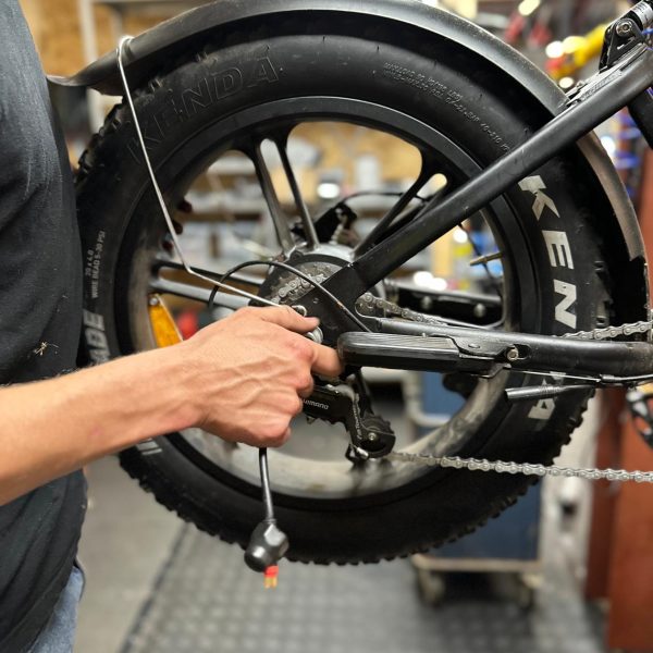 Inspectie van aandrijving en ketting bij elektrische fatbike – kettingspanning afstellen tijdens onderhoud.